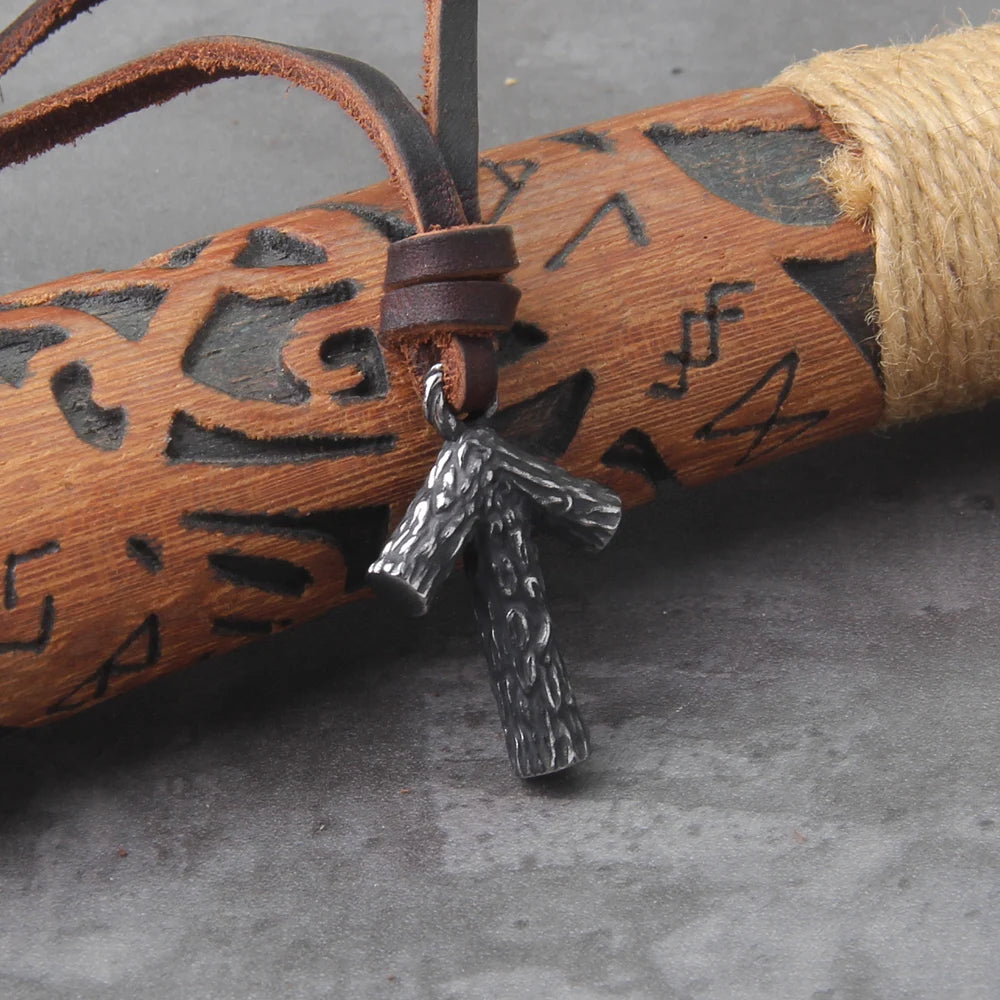 Norse Tiwaz rune amulet with a leather cord.