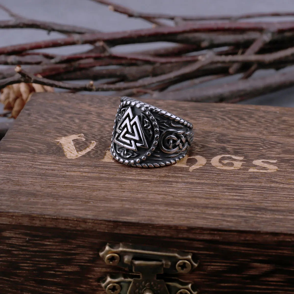 Close-up of Web of Wyrd design on darkened Valknut ring