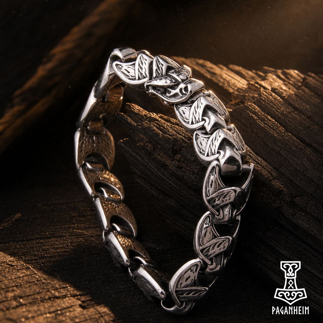 Norse serpent bracelet resting on wooden surface under warm light