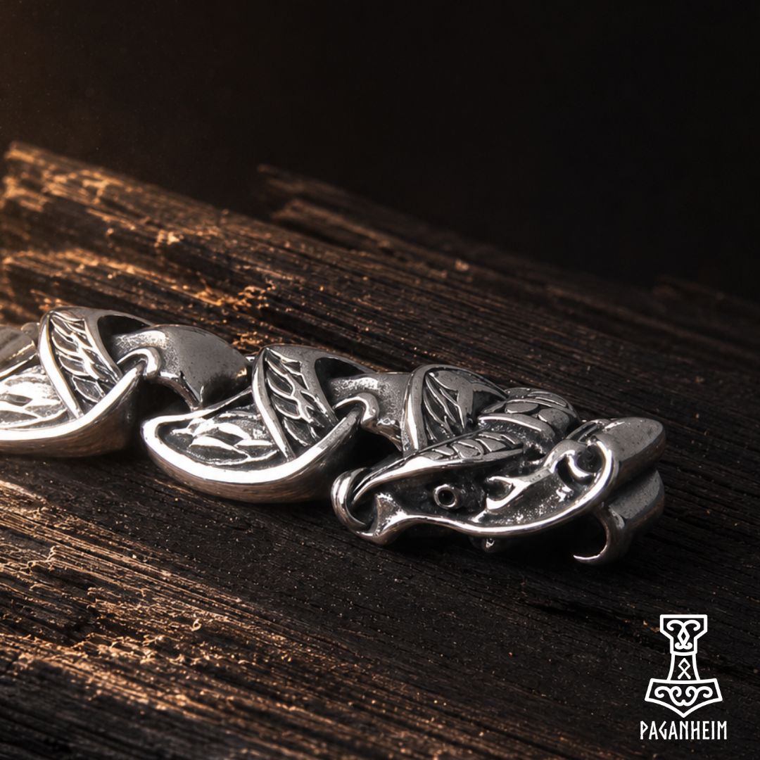 Closeup of serpent bracelet showing fine engraving and polished finish.