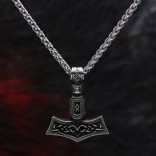 Detailed view of the Othala Mjölnir Amulet, showcasing the intricate etchings of runic heritage.
