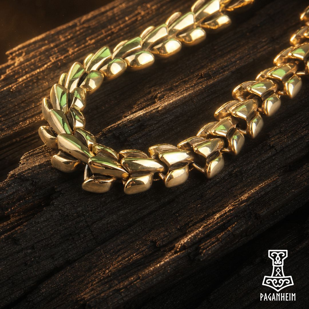 Norse serpent necklace resting on wooden surface under warm light