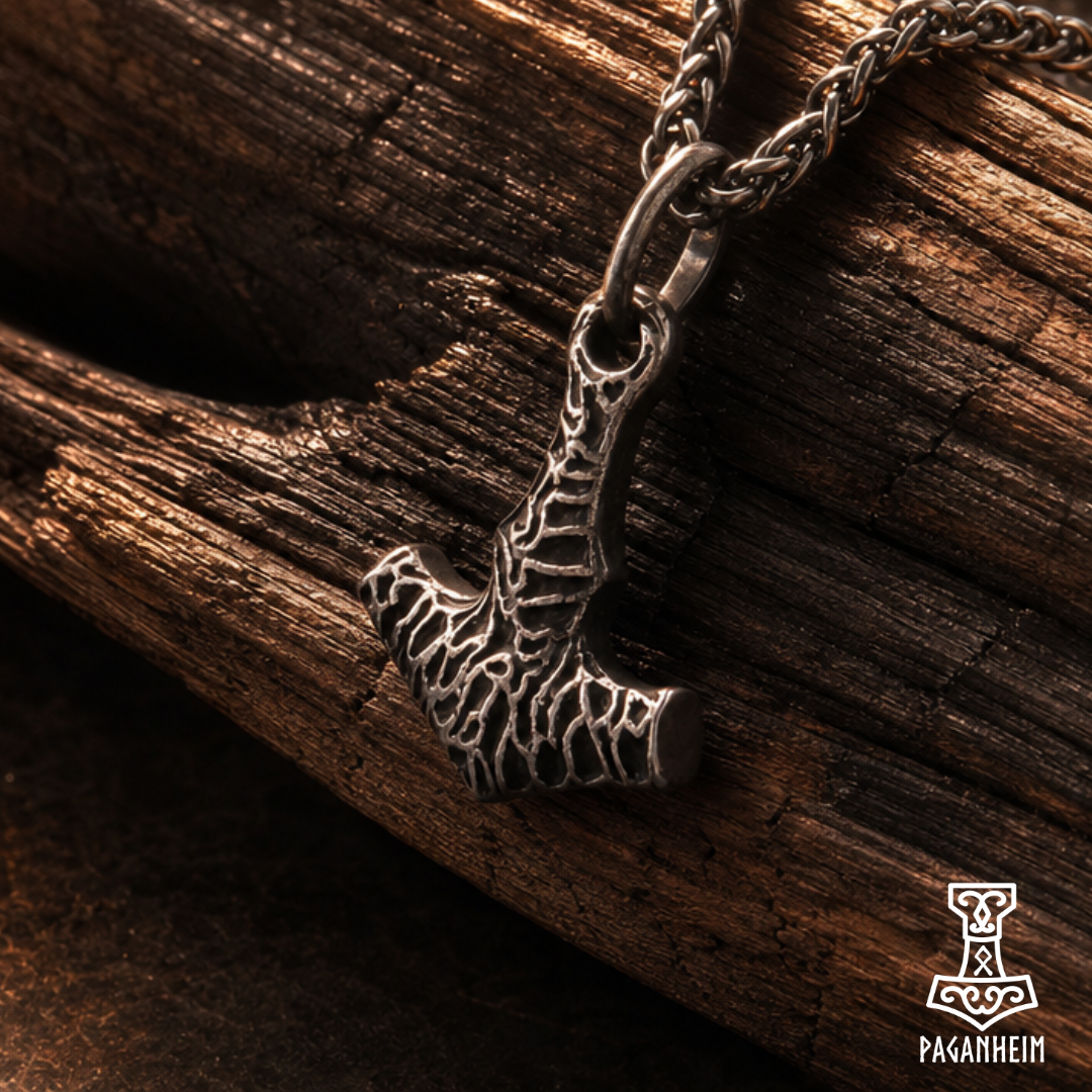 Closeup of Norse Thor’s hammer necklace showing rugged surface and black cord