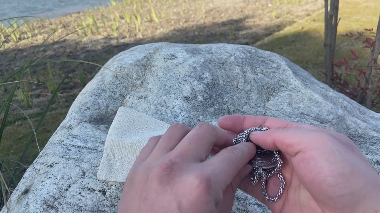 Detail shot of the 'Odin & Triskele' Amulet, illustrating the symbolism tied to the Poem of Skáldskaparmjöðr in Norse mythology.