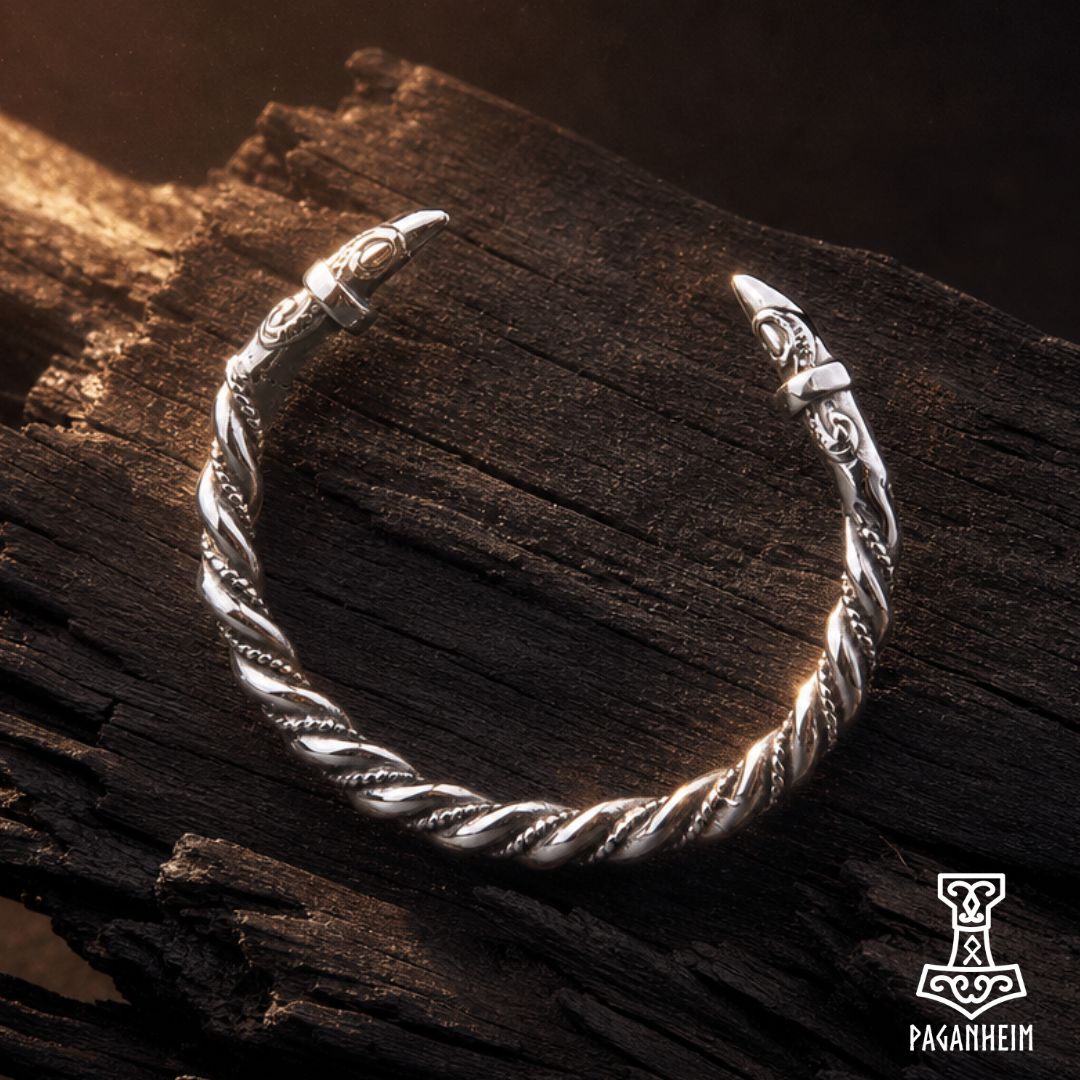 Silver arm ring featuring sculpted raven heads at each end