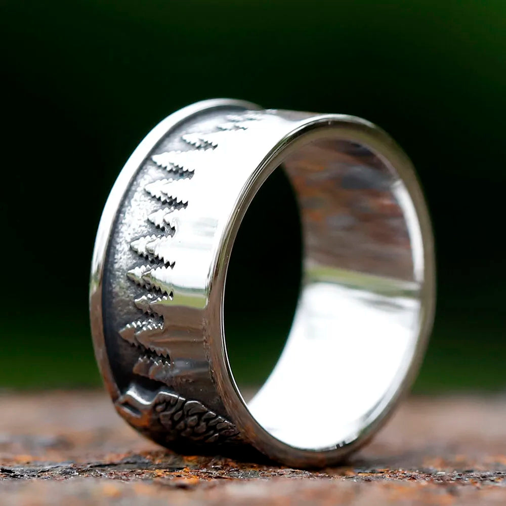 Wolf howling in a pine forest design on a ring.