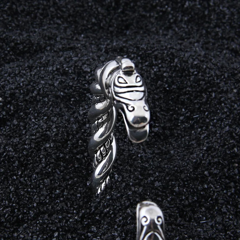 Rod-style arm ring with dragon heads crafted in sterling silver.