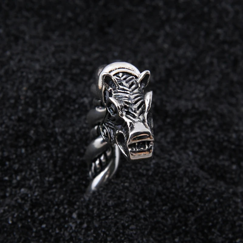 Norse hacksilver-style arm ring featuring wolf heads at each end.