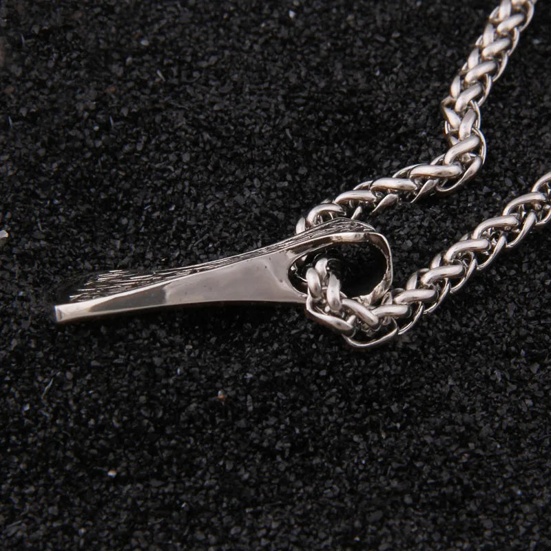 Scandinavian Urnes design on sterling silver axe pendant.