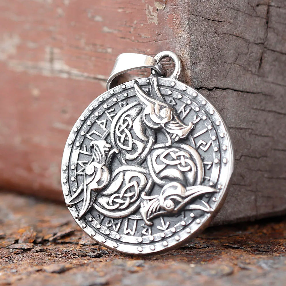 Shield pendant necklace with three intertwined dragon heads and Elder Futhark runes.