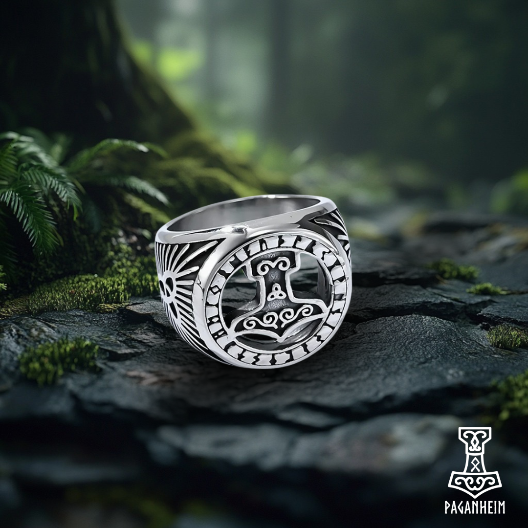 Silver ring featuring Mjölnir design and central triquetra symbol.