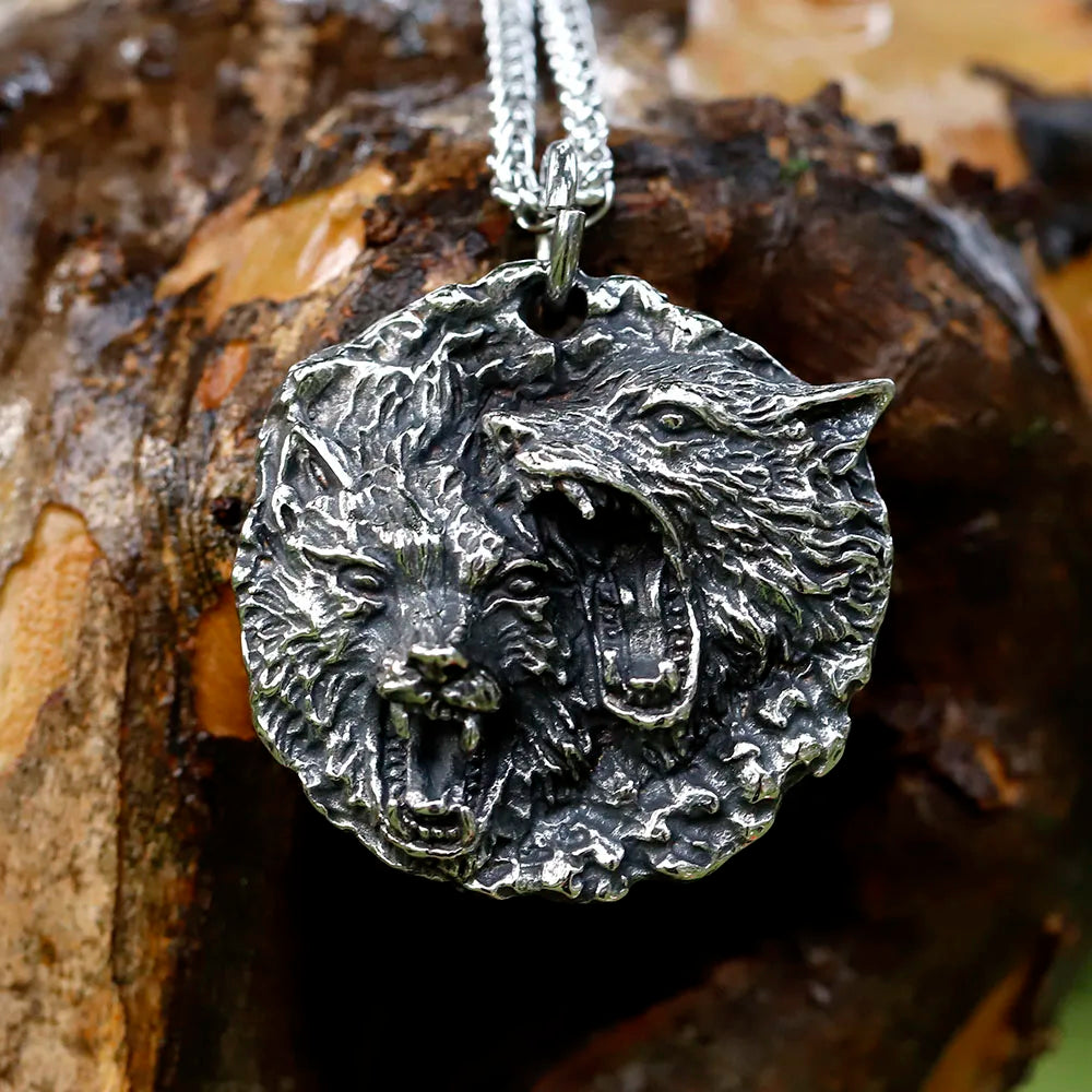 Necklace pendant etched with the open jaws of Sköll and Hati, sons of Fenrir.