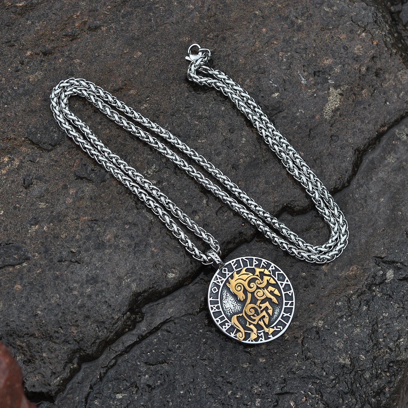 Close-up of the Sleipnir pendant, showcasing intricate gold detailing surrounded by Elder Futhark runes.