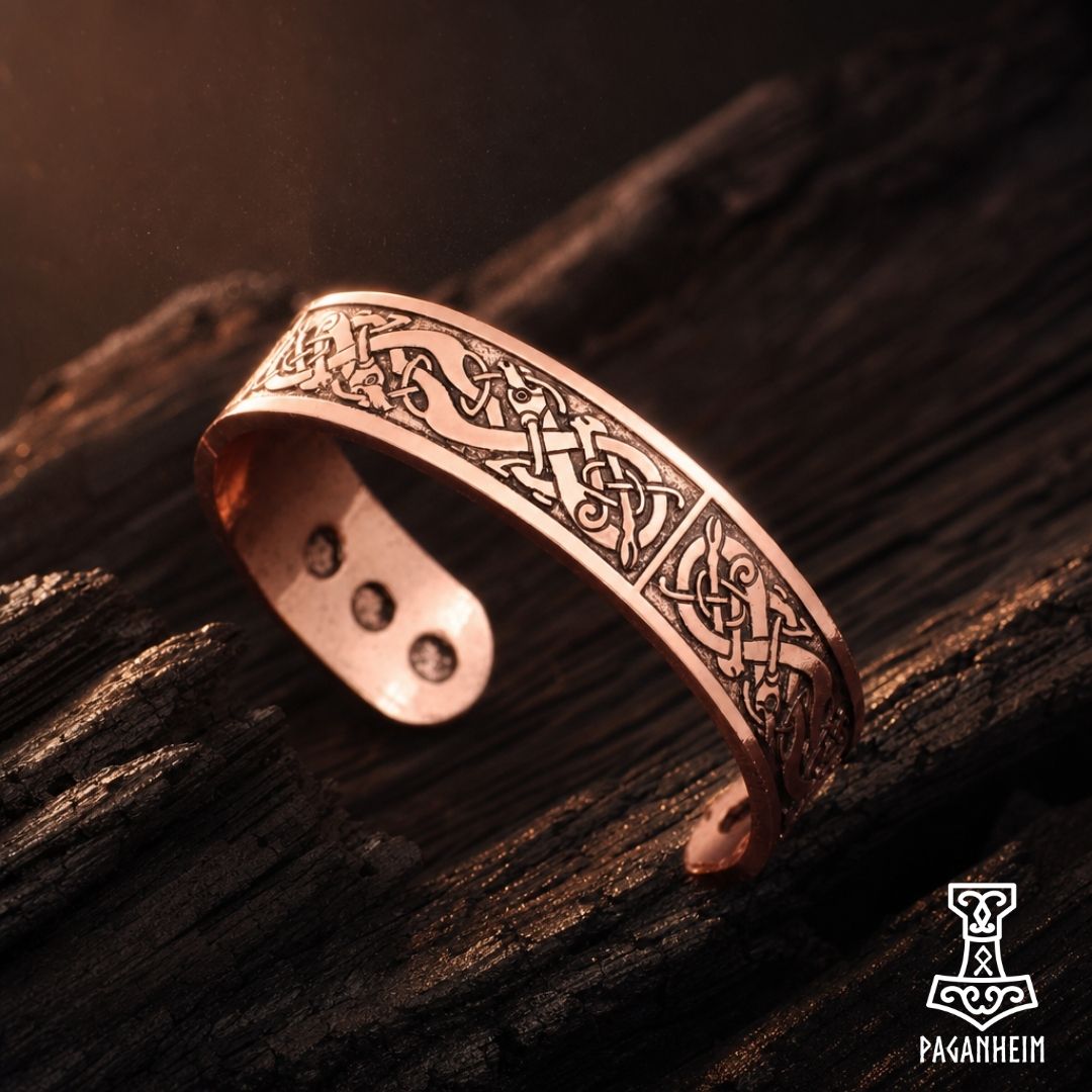 Norse Urnes cuff resting on wooden surface under warm light