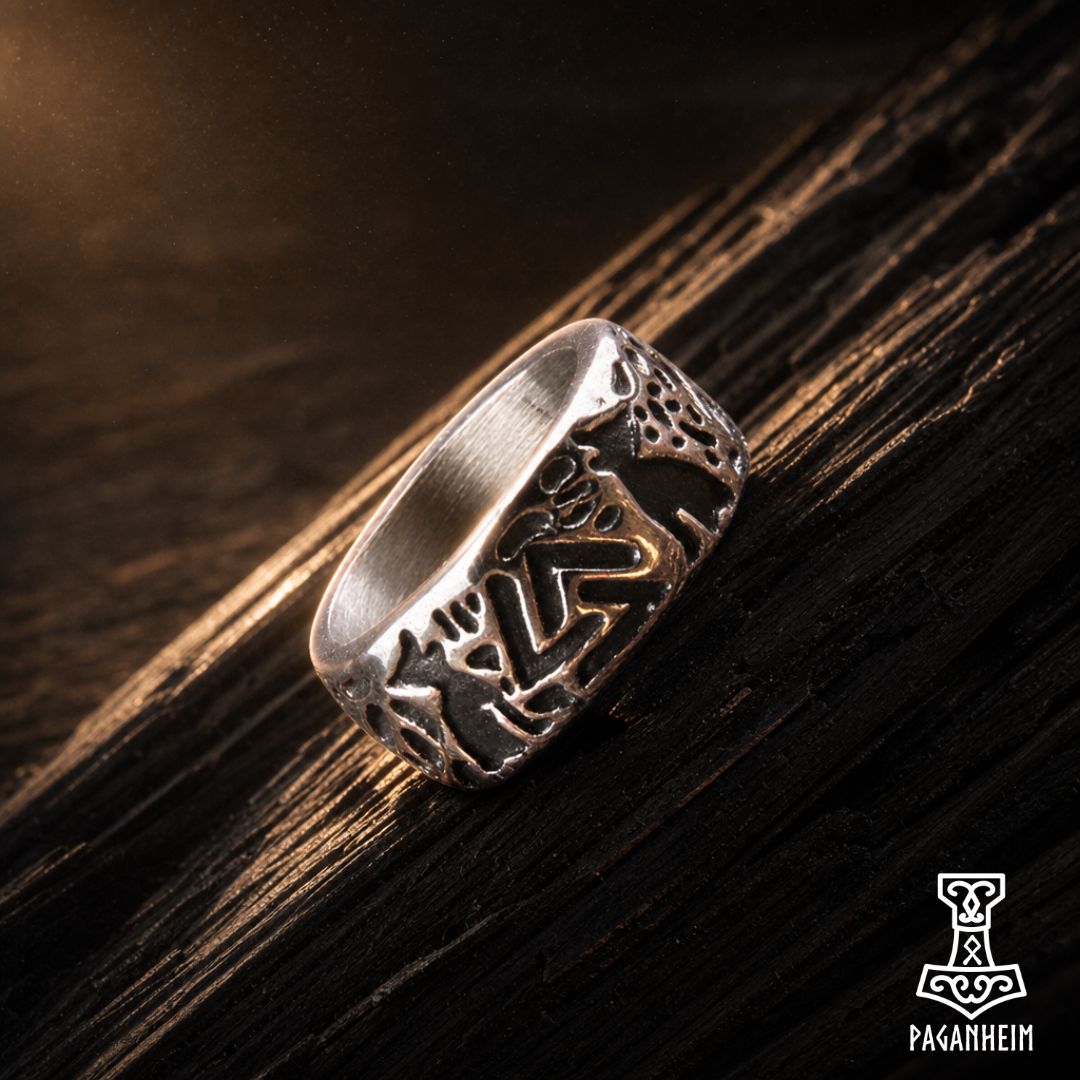 Norse Valknut ring resting on wooden surface under warm light.