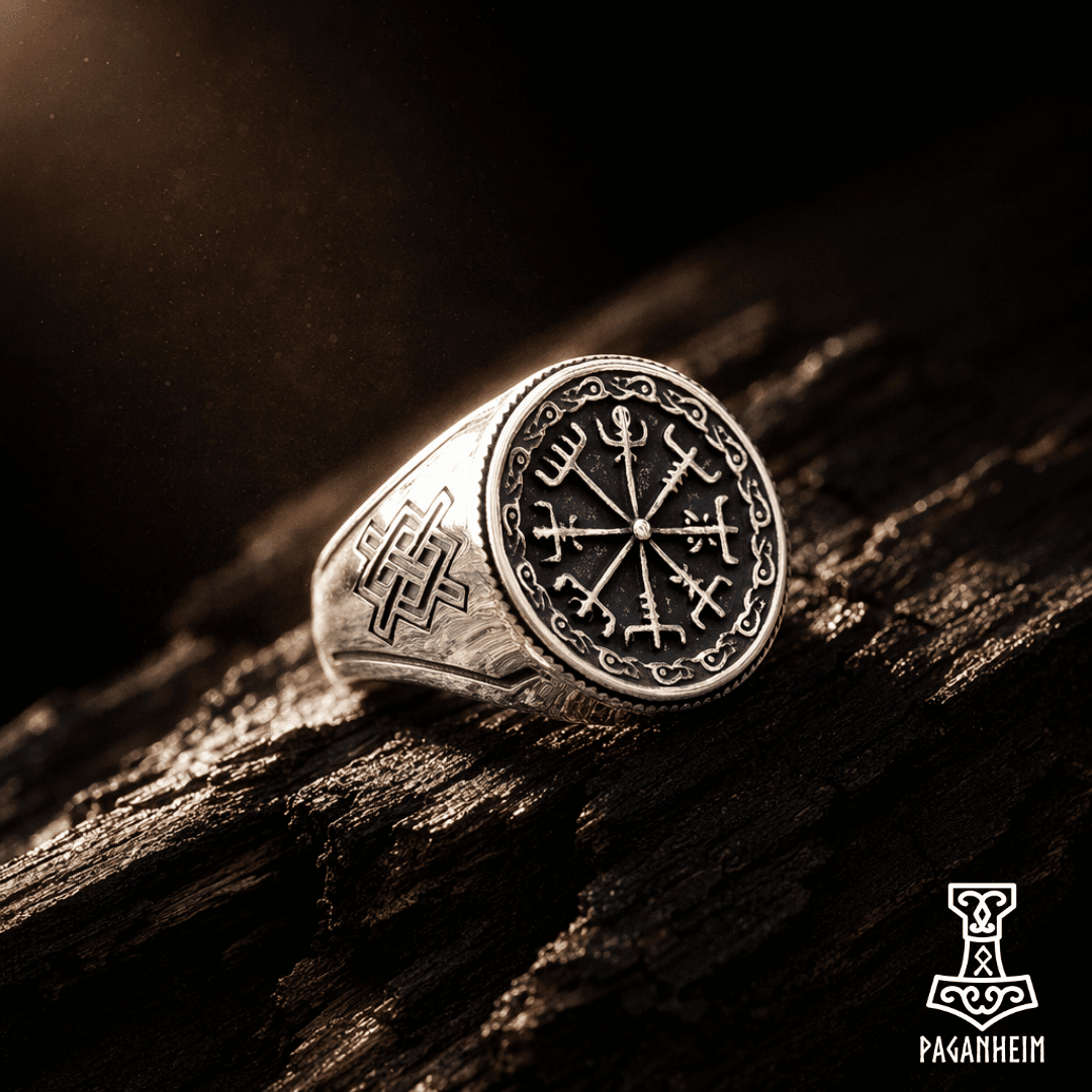 Engraved Norse ring resting on textured wooden surface