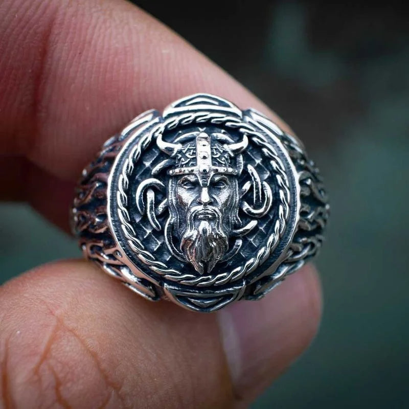 Detailed view of a Norse warrior ring with the face of a Viking and intersected Web of Wyrd patterns, crafted for durability and style.