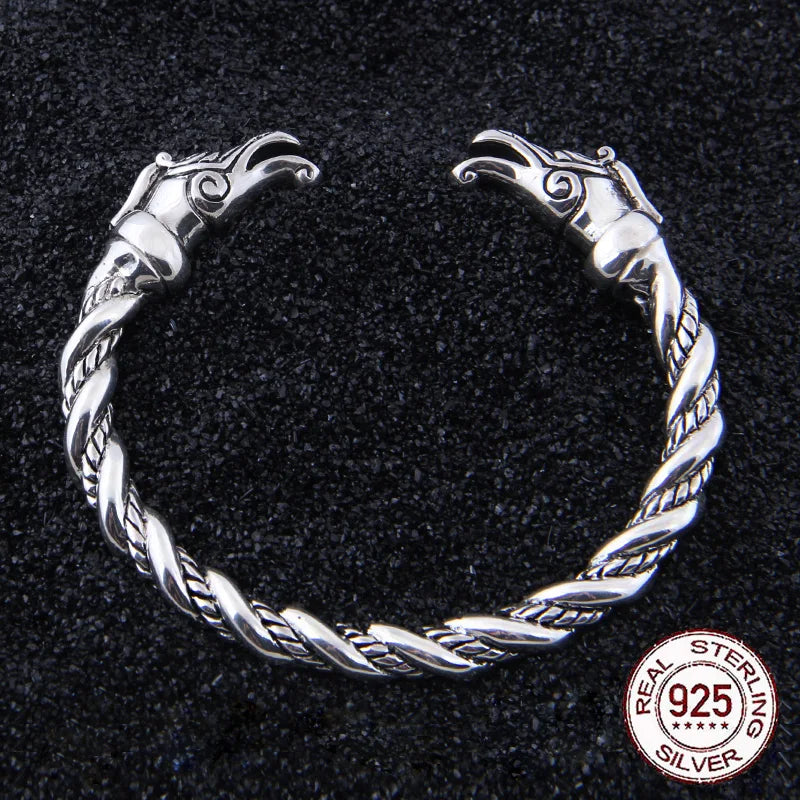 Sterling silver arm ring with dragon head ends inspired by Viking longships.