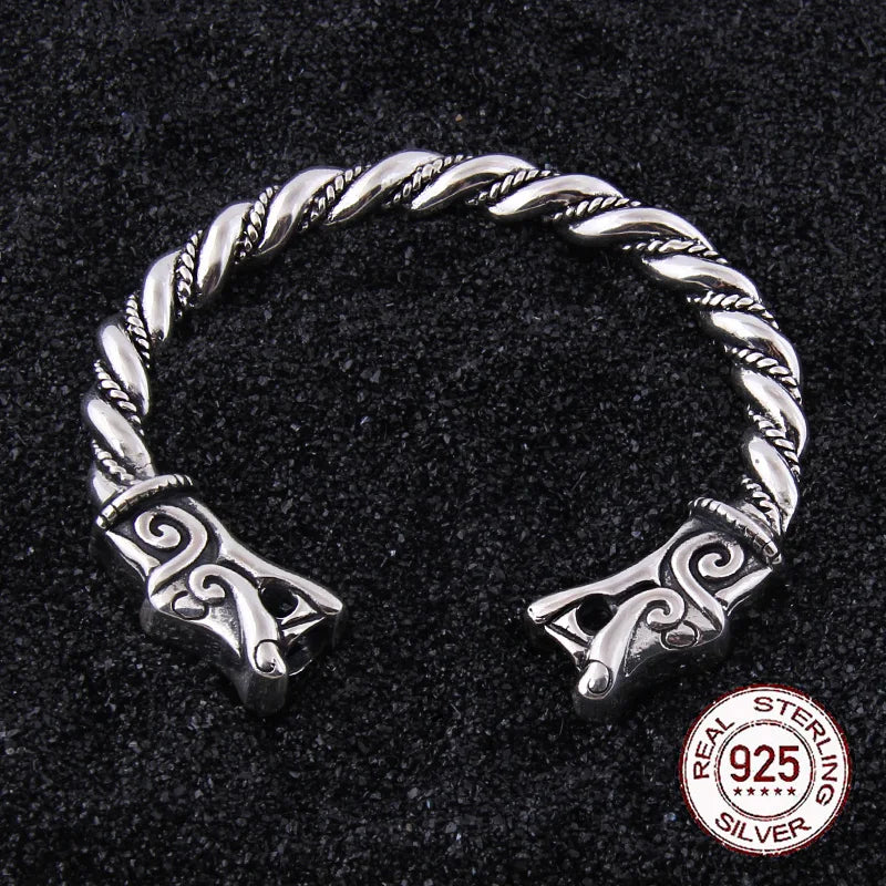 Sterling silver arm ring with dragon heads and a Viking rod design.
