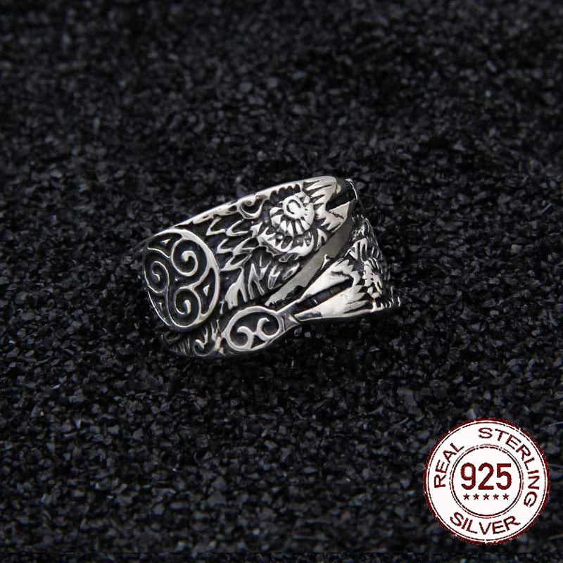 Sterling silver spiral ring with Hugin, Munin, and a Triquetra design.