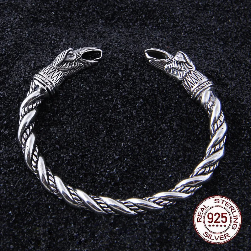 Sterling silver Viking arm ring with a twisted rod design and raven head details.