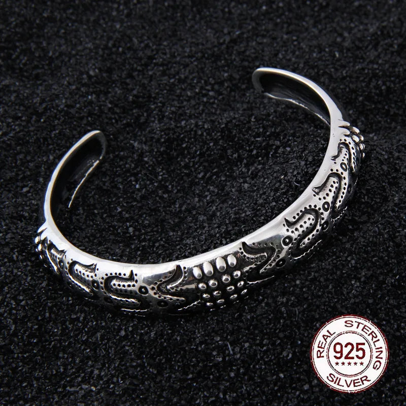 Sterling silver Viking arm ring with deep transverse grooves, adjustable for universal fit.