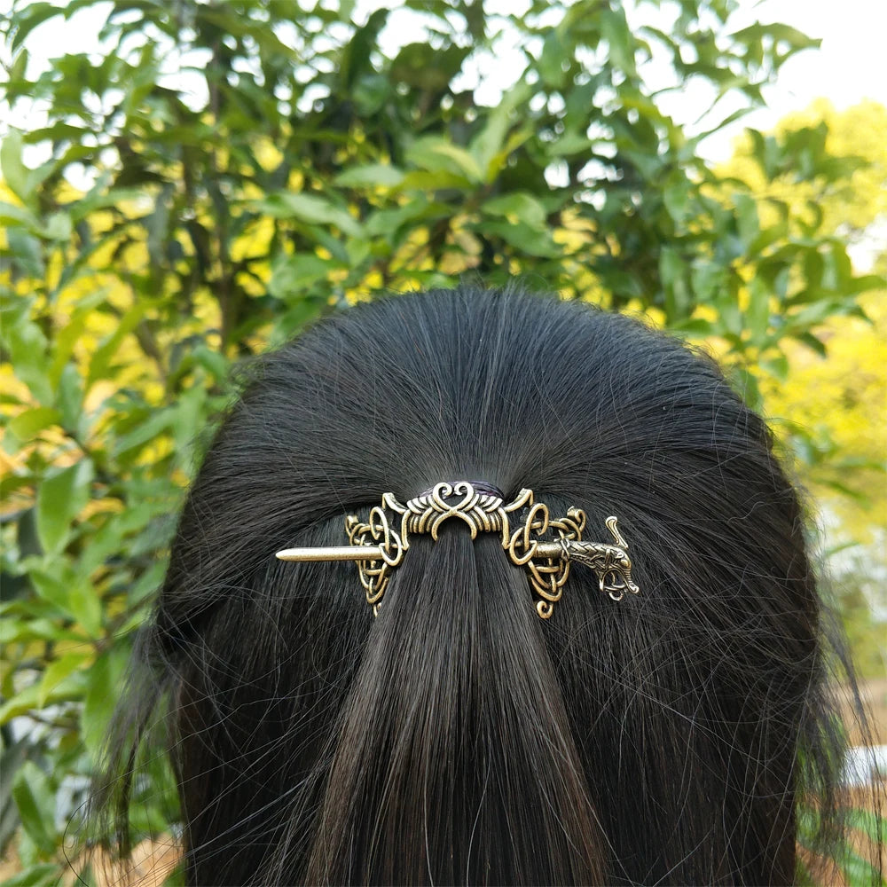 Thin Celtic-style hair pin brooch with intricate artistic details.