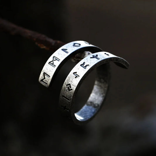 Aged silver Vikingr ring, with a twisted design engraved with Elder Futhark Runes
