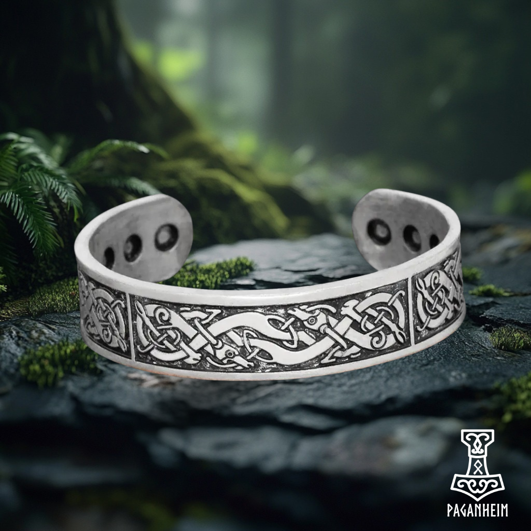 Silver cuff bracelet engraved with Urnes art style inspired by Norse culture.