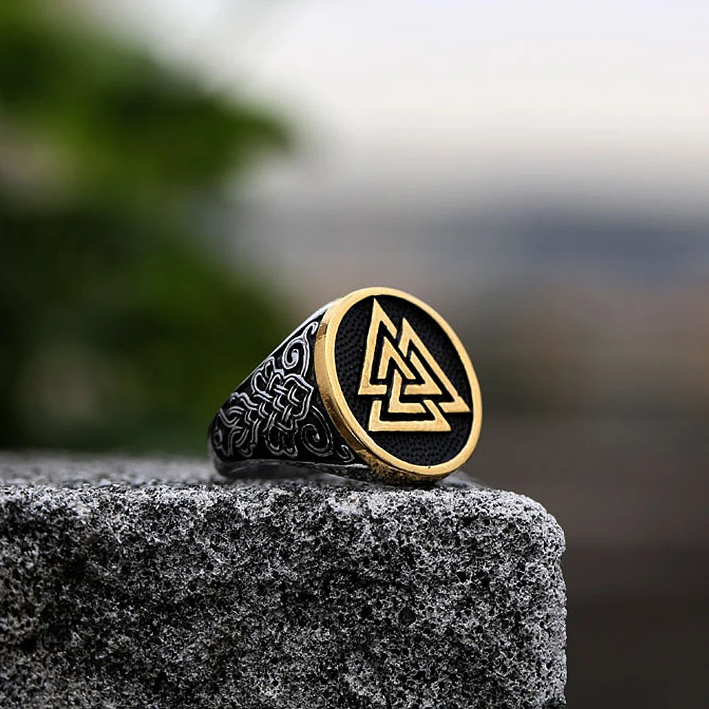 Norse mythology-inspired Valknut ring with detailed engravings and a silver or mixed silver and gold finish, representing fate and bravery.