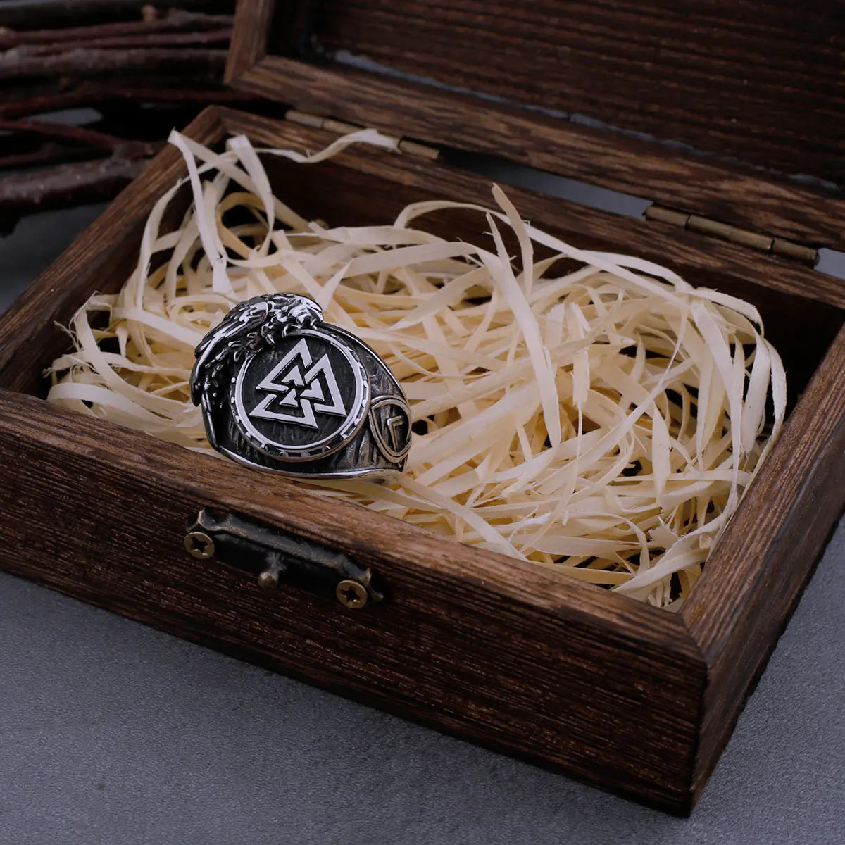 Close-up view of the Valknut ring with a detailed raven wing embossed on the side.