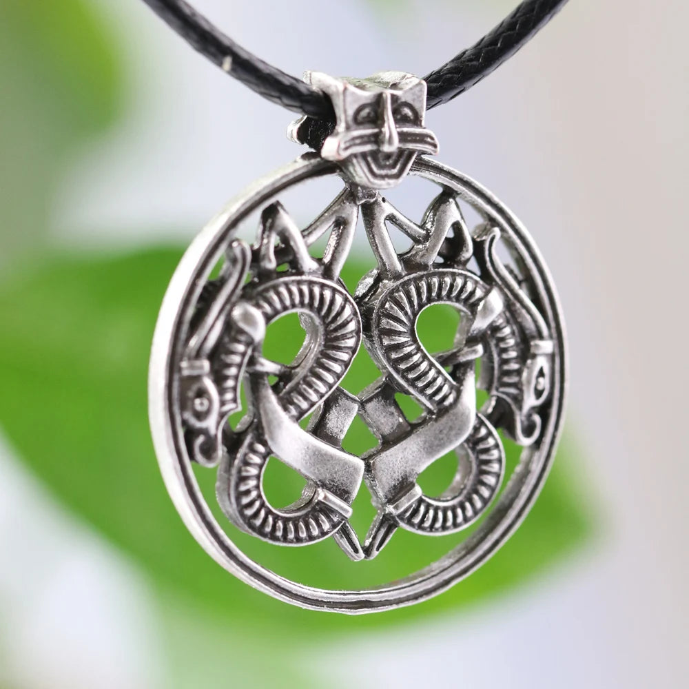 Viking-inspired dragon pendant amulet with interwoven designs.