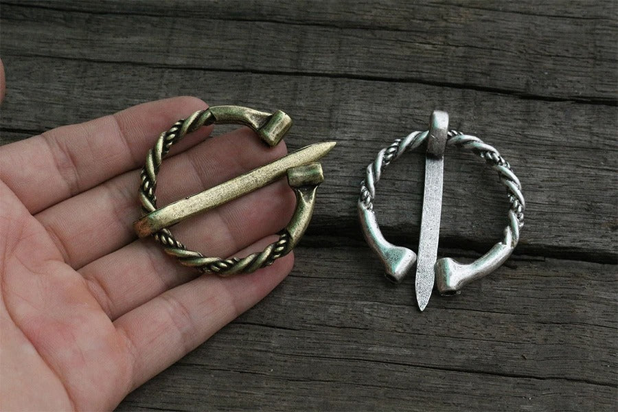 Bronze Viking-style brooch with a twisted hacksilver-inspired design.