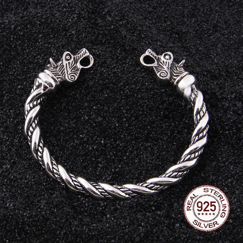 Viking arm ring designed with historical hacksilver functionality and Norse wolf symbolism.