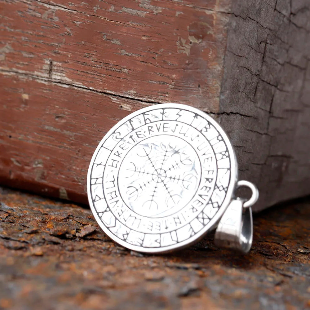 Viking shield necklace featuring dragon heads and runes.