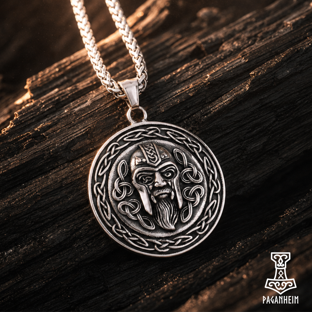 Pendant featuring Odin’s face with knotwork border resting on dark wood